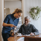 Home health aide caring for senior patient