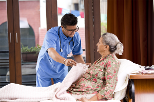 Nurse providing assistance to patient on hospice