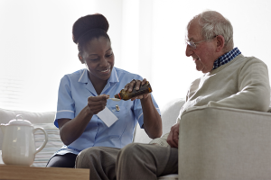 Nurse reminding senior patient to take medication