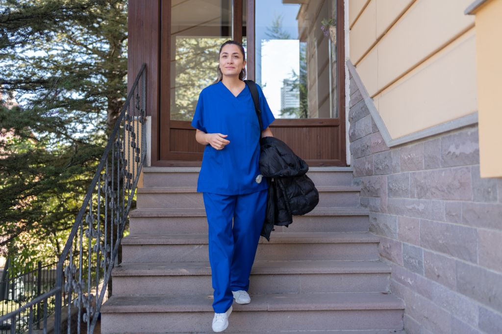 Iowa nurse standing outside patient's home