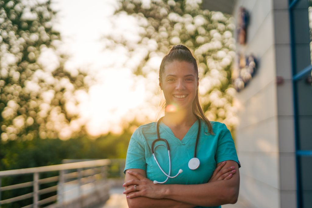 Iowa nurse standing outside patient's home